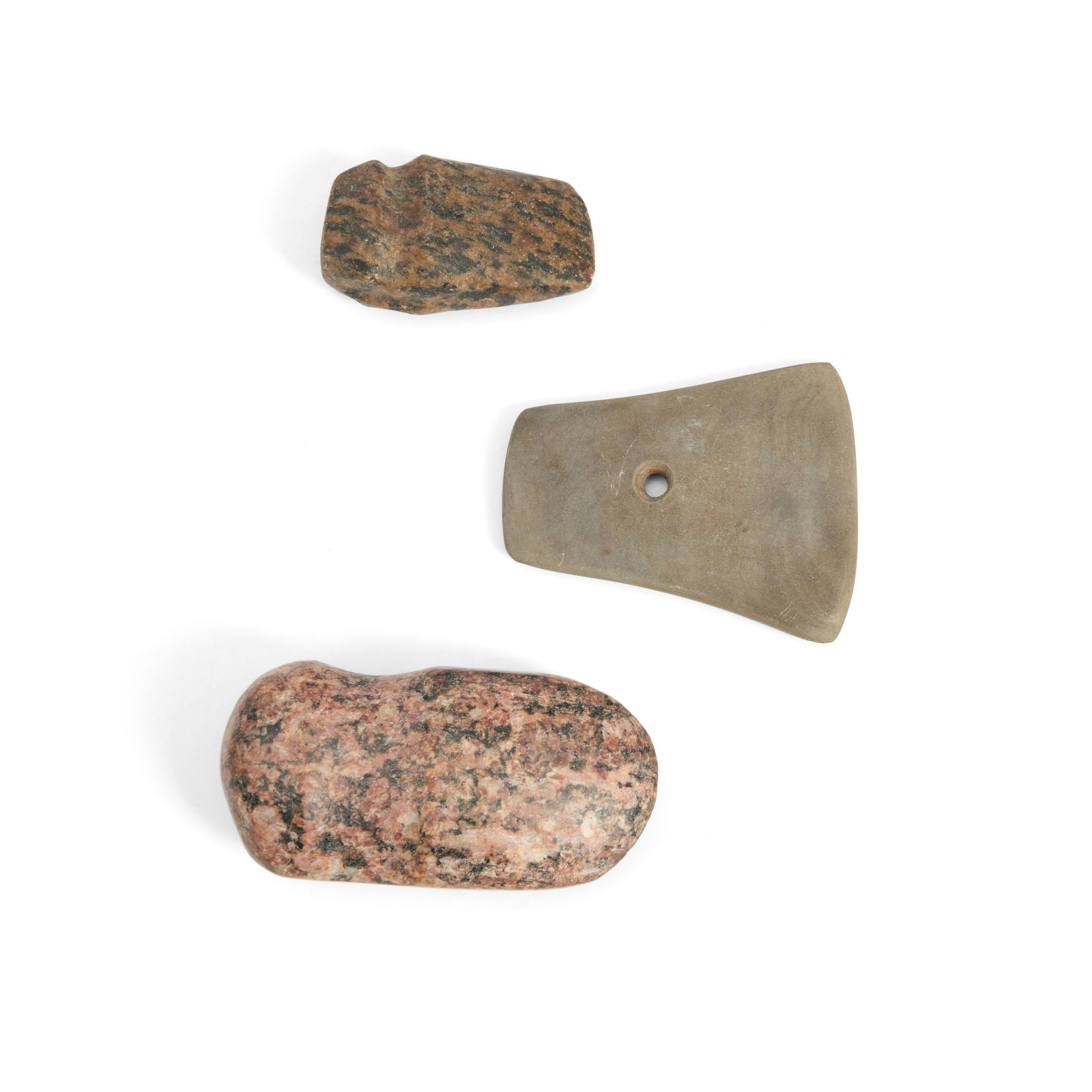 Two Midwestern stone grooved axes with a slate gorget lg. 3 1/8, 2 1/8, and 2 3/4 in.: Two Midwestern stone grooved axes with a slate gorget Muskingum Co. Ohio, two granite grooved axes, together with a slate gorget with a central drilled hole, with 'Muskingum Co. Ohio.' lg. 3 1/8, 2 1/