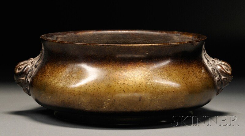 Bronze Censer, China, compressed form with twin Buddhis: Bronze Censer, China, compressed form with twin Buddhist lion head handles, lip slightly splayed, constricted neck, with four-character "Yu Tang Qing Xi" mark cast in the base, dia. 7, ht. 4 in.