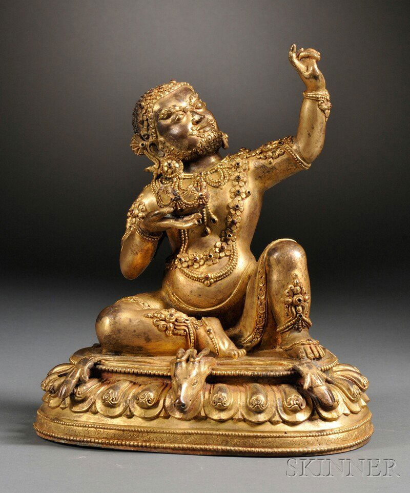 Gilded Seated Figure, Sino-Tibetan, depicting Buddha we: Gilded Seated Figure, Sino-Tibetan, depicting Buddha wearing jewels, seated on the skin of a ram on top of a lotus base, holding a bowl in his right hand, his left in apana mudra, ht. 10 in.