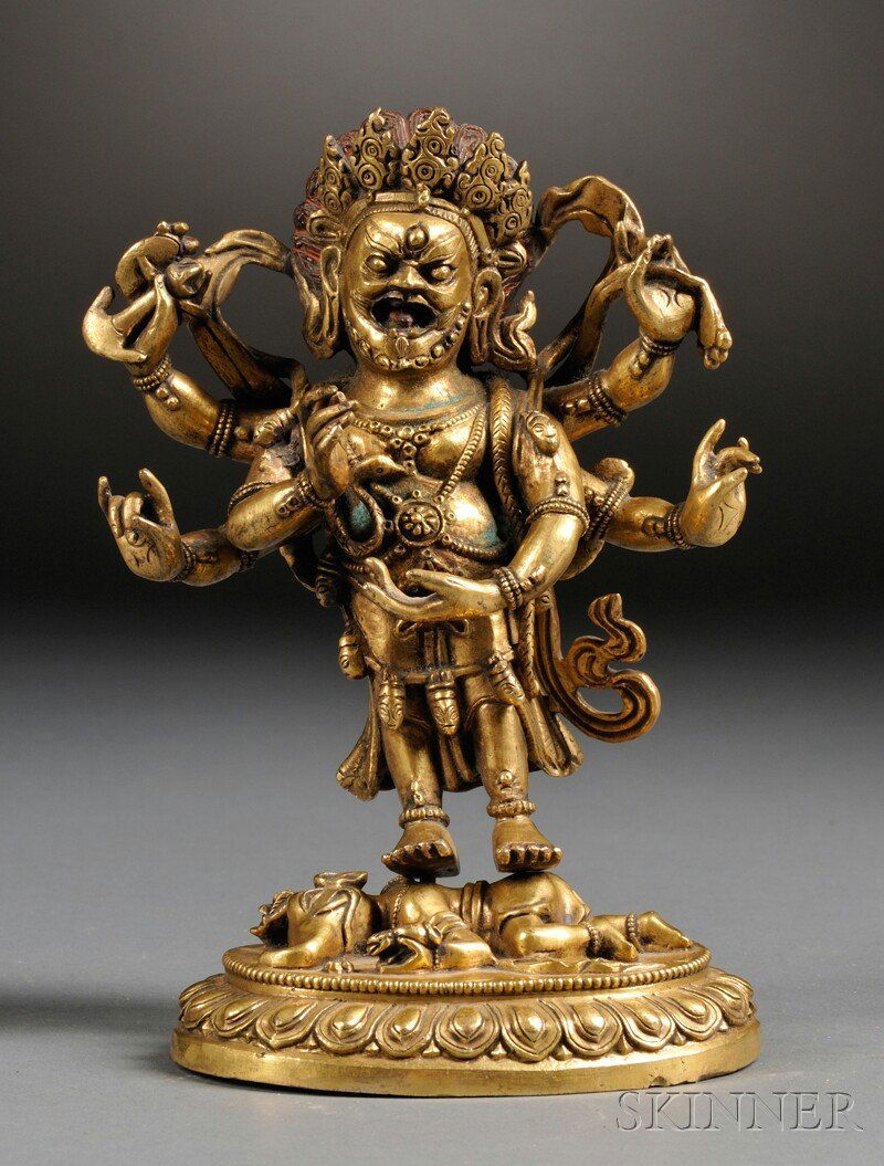 Gilt-bronze Buddhist Image, Sino-Tibetan, six-armed tan: Gilt-bronze Buddhist Image, Sino-Tibetan, six-armed tantric wrathful deity, each arm holding different items, in different mudras, probably Yama, standing on a elephant mask figure on a lotus base, ht