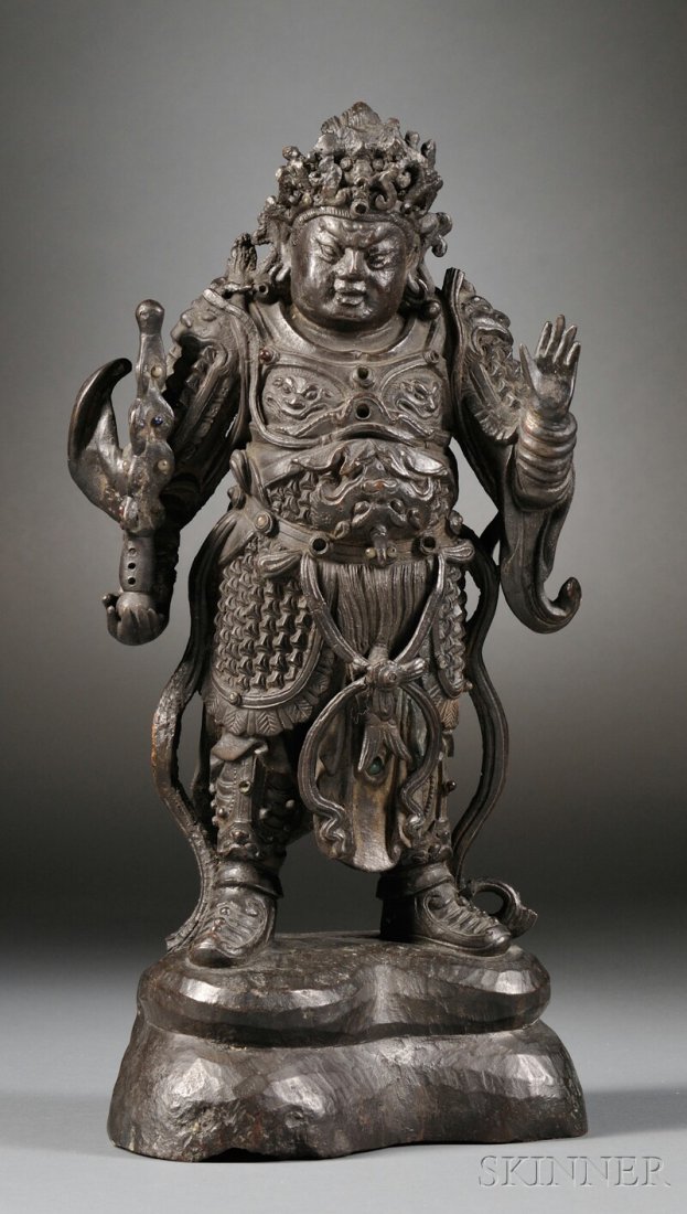 Bronze Buddhist Guardian Figure, China, Ming dynasty (1: Bronze Buddhist Guardian Figure, China, Ming dynasty (1368-1644), standing on a rock formation in a military uniform depicting lion heads on the breast plates, sleeves, and headpiece, inlaid with hard