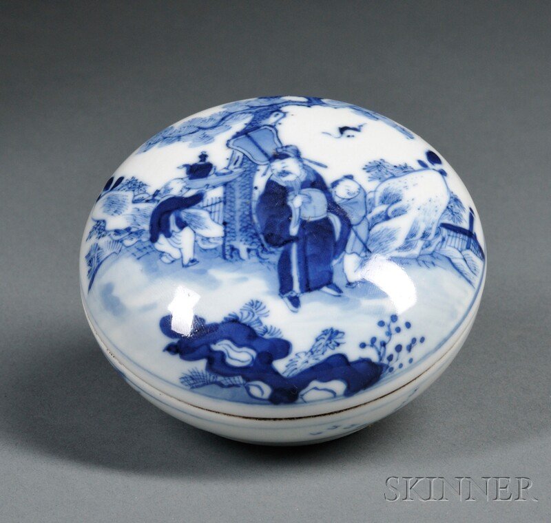 Blue and White Seal Paste Box, China, 18th century, fla: Blue and White Seal Paste Box, China, 18th century, flattened round shape, cover depicting an official and attendants preparing tea, the base depicting a hut, bridge, and geese in flight, six-characte