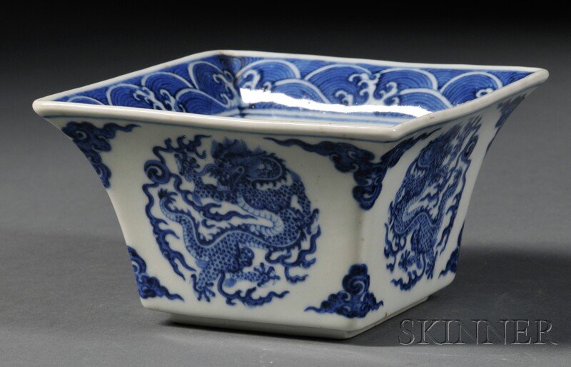Square Blue and White Bowl, China, 19th century, each s: Square Blue and White Bowl, China, 19th century, each side painted with a dragon roundel, the interior with a crashing wave border and central shou character, six-character Qianlong mark on base, ht. 
