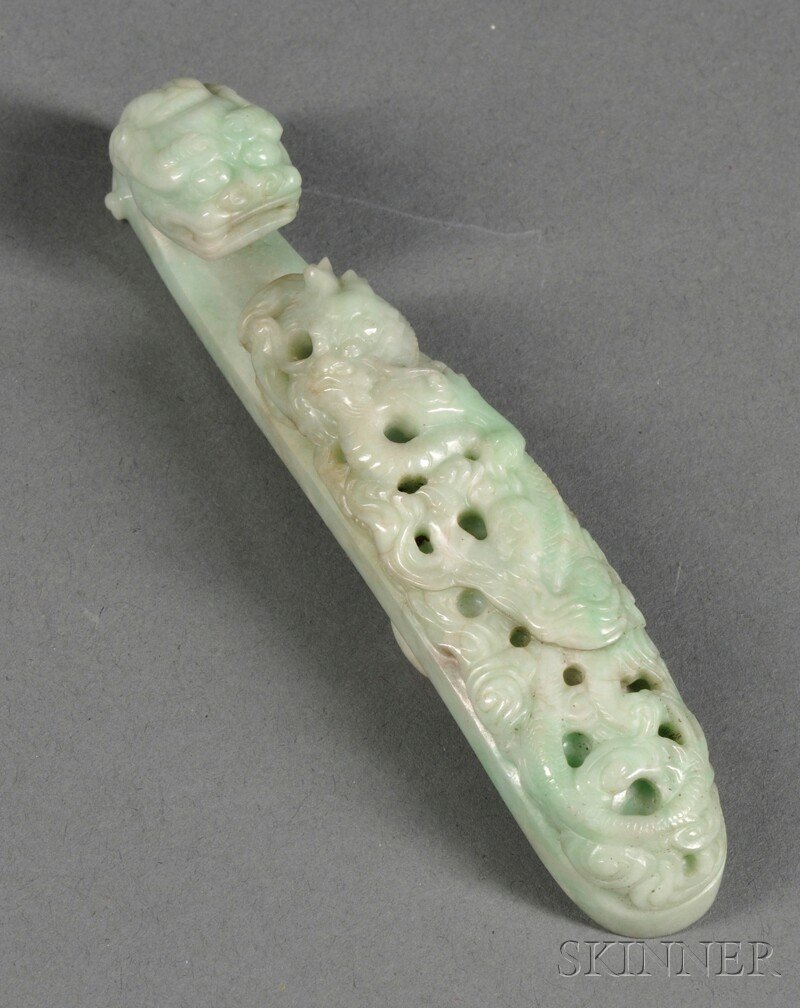 Jade Hook, China, a dragon's head carved in relief conf: Jade Hook, China, a dragon's head carved in relief confronts a chilong crouched along the body, stone of pale green color, lg. 4 in.