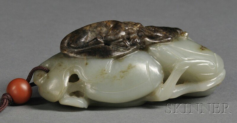 Jade Carving, China, depicting two dogs standing on mel: Jade Carving, China, depicting two dogs standing on melons, stone of pale green with russet markings and inclusions, lg. 3 in.