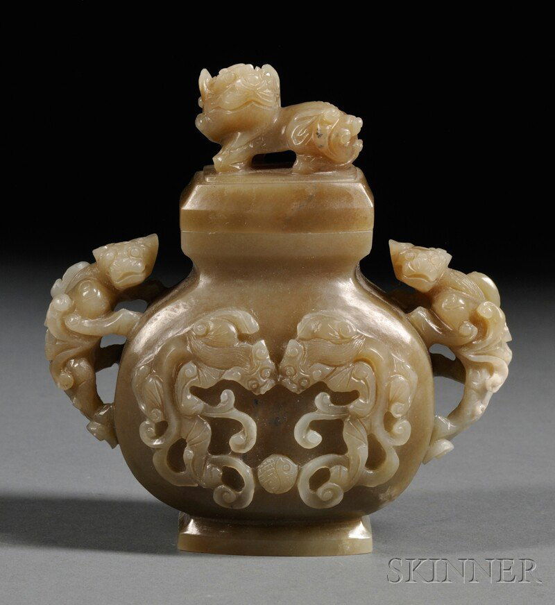 Jade Covered Jar, China, carved in relief with a pair o: Jade Covered Jar, China, carved in relief with a pair of scrolling dragons in pursuit of pearls, with chilong handles, a lion seated on the cover, stone of gray-celadon color, ht. 5 in.