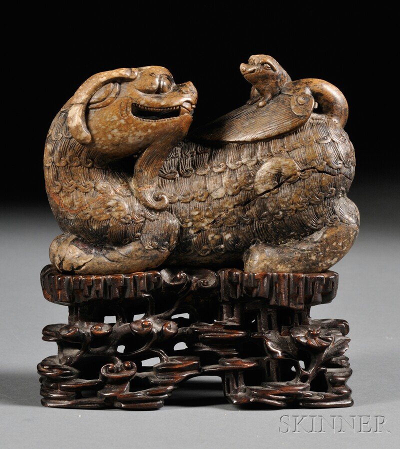 Soapstone Carving and Stand, China, depicting a shensho: Soapstone Carving and Stand, China, depicting a shenshou turning its head to another one on its back, stone of dark brown color, lg. 5 in.