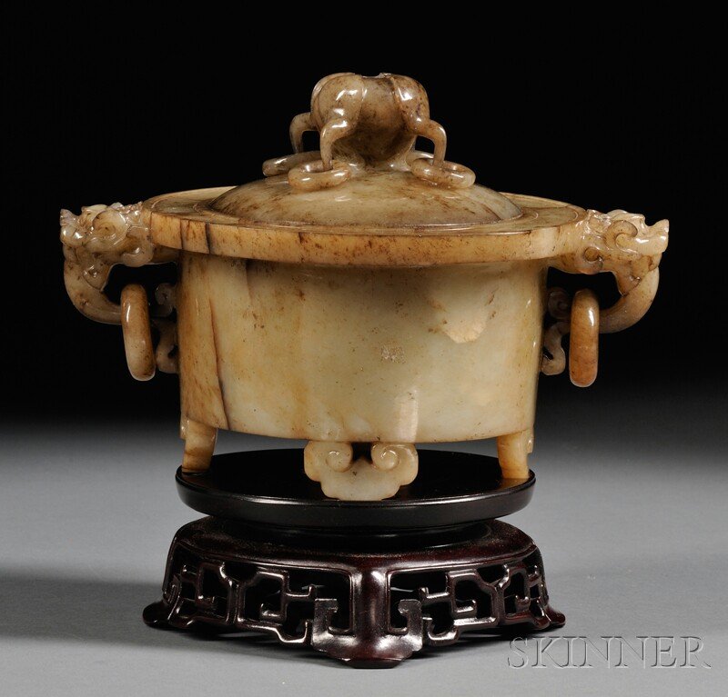 Soapstone Censer, China, supported on four cloud-shape: Soapstone Censer, China, supported on four cloud-shape feet, with dragon mask handles suspending loose rings, with lotus finial with four rings, stone of gray color with dark markings and inclusions, 