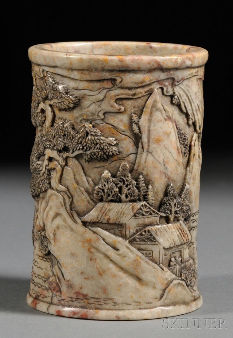 Soapstone Brush Pot, China, carved in relief with a mou: Soapstone Brush Pot, China, carved in relief with a mountain, houses, trees, figures, and a river, stone of gray color with dark markings and inclusions, ht. 5 in.