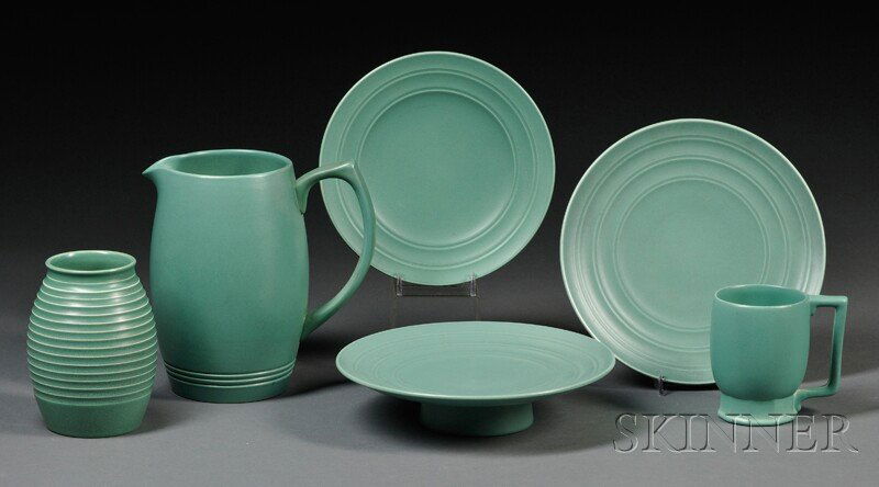 Six Wedgwood Matte Green Glazed Keith Murray Desig: Six Wedgwood Matte Green Glazed Keith Murray Design Items, England, mid-20th century, including a barrel-shape vase with concentric rings, ht. 5 1/2; mug, ht. 4 1/8; water pitcher, ht. 8; plate, dia.