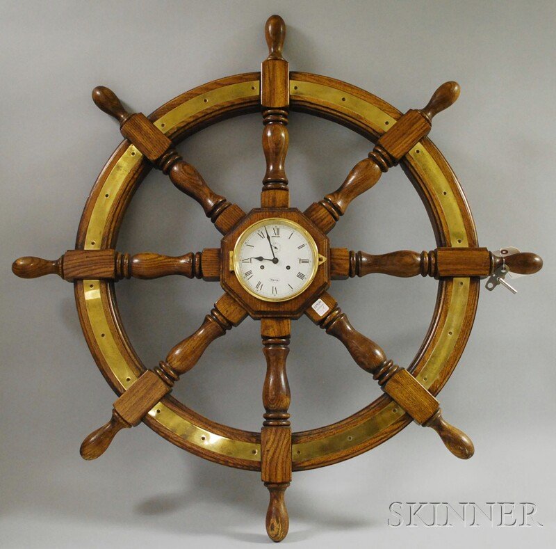 Ridgeway Ship's Wheel Wall Clock, Germany, Roman: Ridgeway Ship's Wheel Wall Clock, Germany, Roman numeral metal dial with brass bezel centering a turned oak and brass ship's wheel, eight-day brass spring-powered time and half-hour strike movement, o