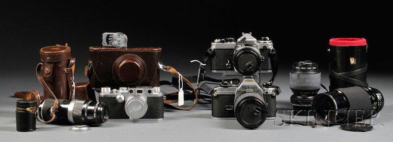 Collection of Cameras and Accessories, Including a: Collection of Cameras and Accessories, Including a Leica IIIF with a screw mount Summatar 50mm F2 lens, a Hektor 135mm F4.5 lens and view finder, Leica meter and booster cell; Nikon FE with a 50mm 1.8