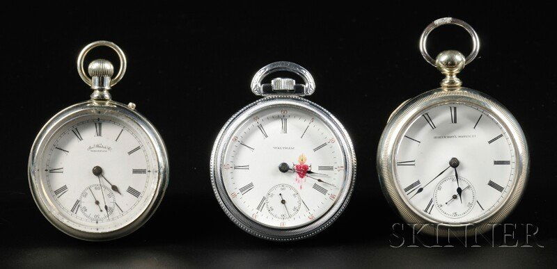Three Open Face American Watches, American Waltham: Three Open Face American Watches, American Waltham Watch Company and Elgin National Watch Company, the first in a nickel "Defiance" case, enameled Roman numeral dial with "bleeding heart" insignia, fu