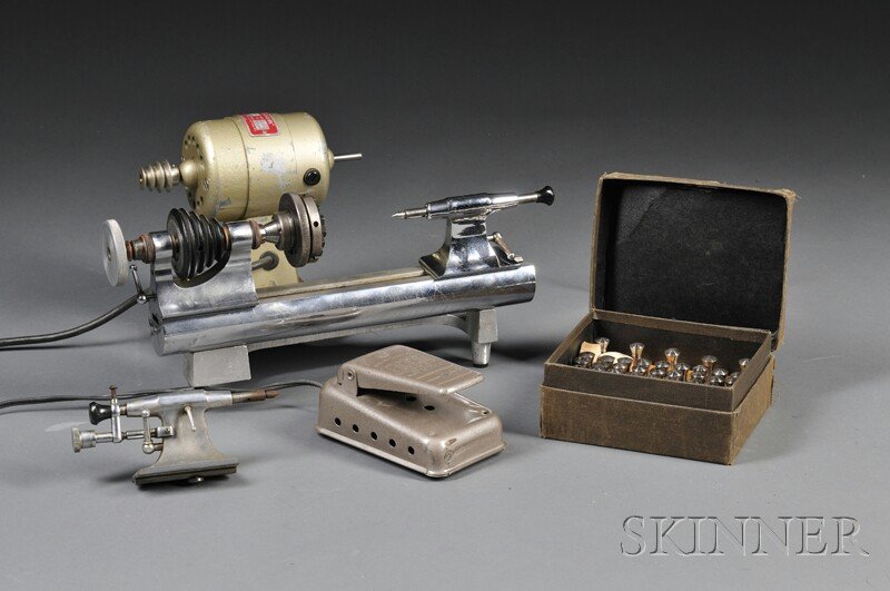 Nickel Finish Watchmaker's Lathe, headstock end st: Nickel Finish Watchmaker's Lathe, headstock end stamped Moseley, Made in U.S.A, tailstock end stamped C. & E. Marshall Co., 12-in. bed, head stock, two different tail stocks, all mounted on an aluminu