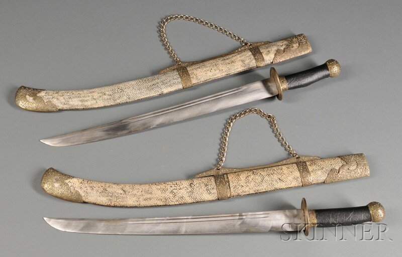 Pair of Turkish Swords, 18 1/4- in. single edge st: Pair of Turkish Swords, 18 1/4- in. single edge steel blade with each side having double Fullers, engraved brass pommels and cross-guards, sharkskin scabbard with brass engraved locket and chape.