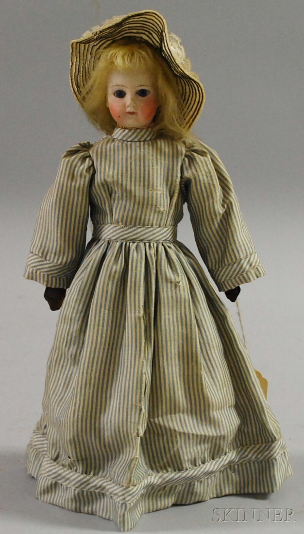 German Bisque Doll, closed mouth flanged head attac: German Bisque Doll, closed mouth flanged head attached to cloth body, dark leather arms, clothing sewn on around neck, ht. 12 in.