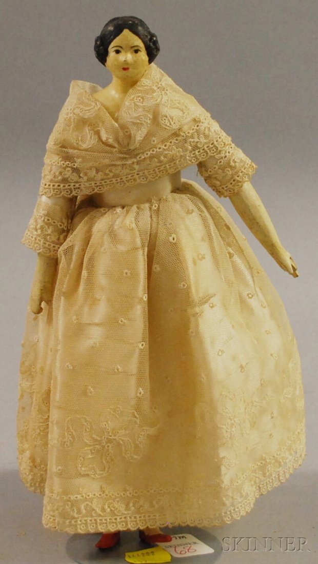 Small Black-haired Papier-mache Shoulder Head Doll,: Small Black-haired Papier-mache Shoulder Head Doll, Germany, hair with curls on sides of face, bun in back, kid "milliner's model" body, wooden lower limbs, red-painted shoes, ht. 10 in.