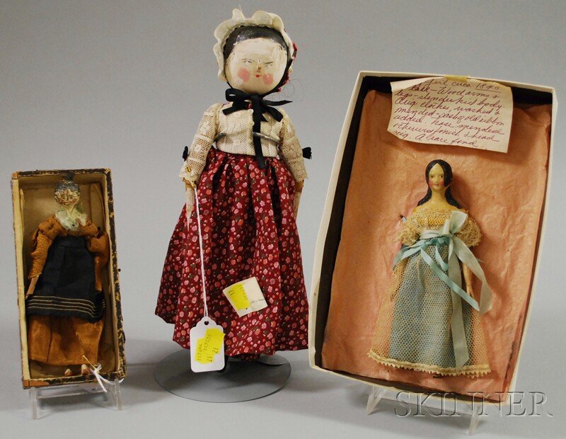 Three Early Wooden and Papier-mache Dolls, a small: Three Early Wooden and Papier-mache Dolls, a small jointed Tuck wooden with comb, ht. 6 1/2; a papier-mache "milliner's model" with long curls, kid body, wooden limbs, ht. 7; an English peg wooden, ht