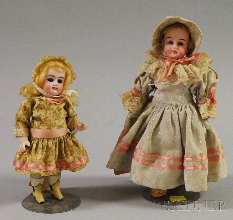 All-Bisque Kestner and a Gbr K Doll, Germany, Kest: All-Bisque Kestner and a Gbr K Doll, Germany, Kestner with brown sleep eyes, closed mouth, blonde wig, swivel neck, molded yellow boots, ht. 7; Gbr K with a sunburst, open mouth, blonde wig, jointed w