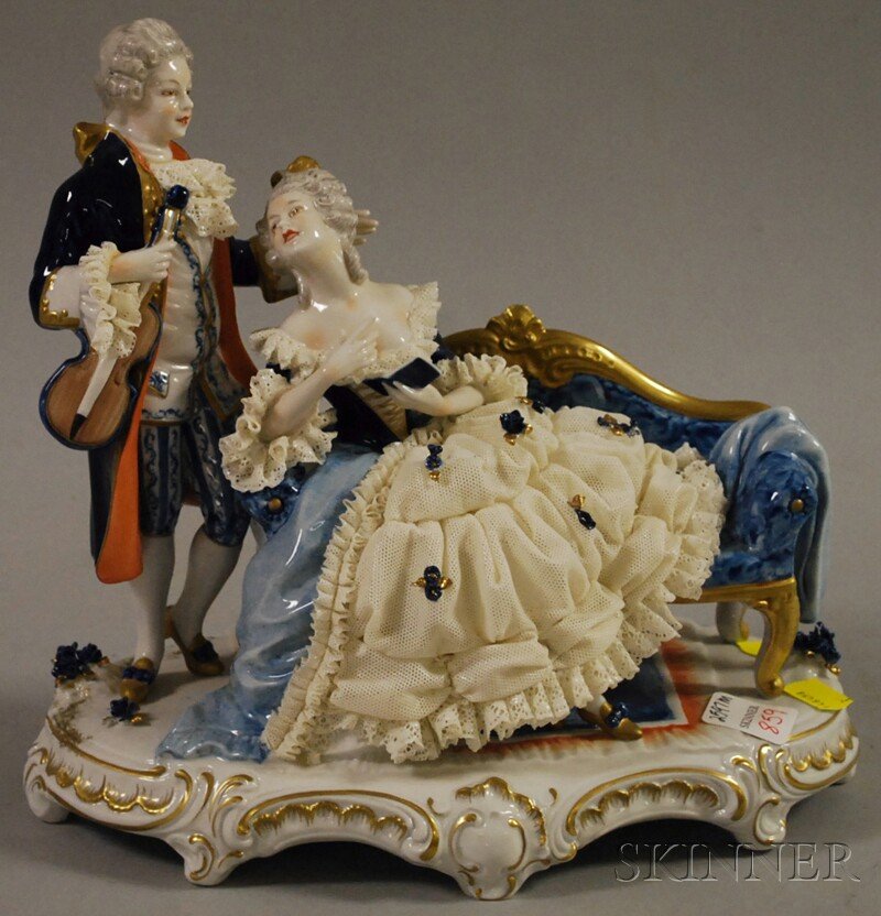 Unter Weiss Bach Porcelain Figural Group, Germany,: Unter Weiss Bach Porcelain Figural Group, Germany, 20th century, marked to base, depicting a lady seated on a blue upholstered sofa, attended to by a gentleman with a violin, ht. 9 3/4, lg. 10 1/2 in.