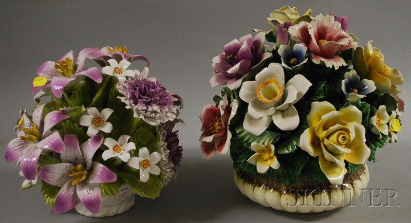 Two Capodimonte Porcelain Basket-form Floral Arran: Two Capodimonte Porcelain Basket-form Floral Arrangements, a white ceramic latticework basket with purple and white lilies and mums, and a fluted two-tone jardiniere with an assortment of multicolored