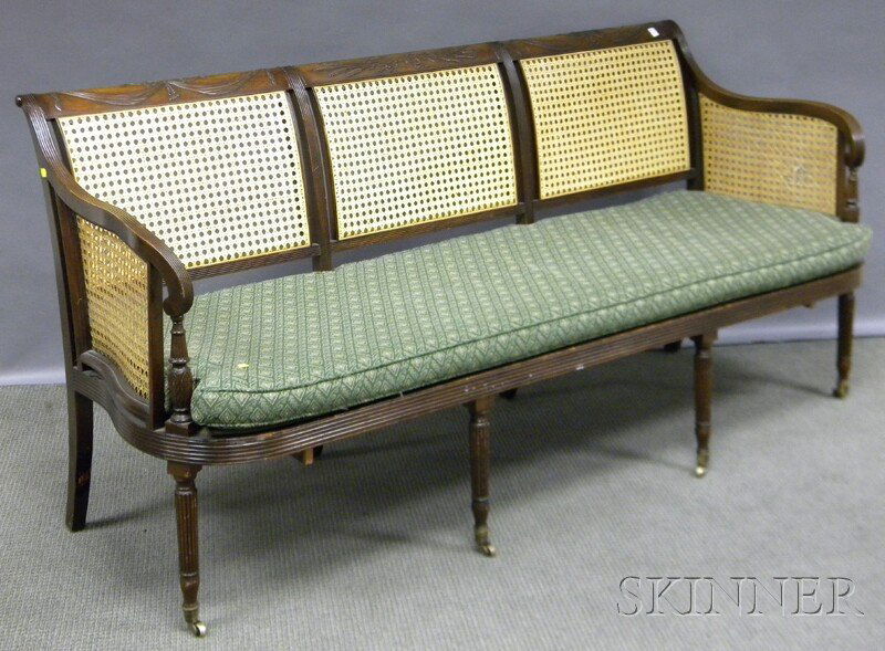 Regency-style Caned and Carved Mahogany Sofa with: Regency-style Caned and Carved Mahogany Sofa with Upholstered Seat and Cushion, 20th century, (even finish, some wear, right side with caning break, no caning at seat and some loose seat stretchers, l
