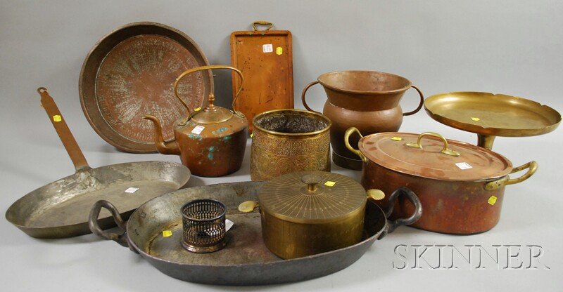 Ten Pieces of Brass, Copper, and Metalware, inclu: Ten Pieces of Brass, Copper, and Metalware, including copper Dutch oven, pan, hot water kettle, tray, and urn, brass tazza, covered pot, Near Eastern vessel, and a metal pan.