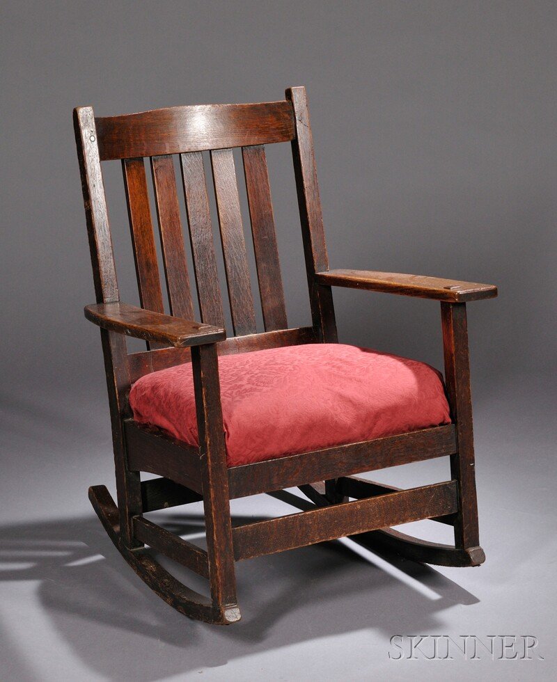 , L. & J. G. Stickley Rocking Chair, Oak and uphols: L. & J. G. Stickley Rocking Chair Oak and upholstery Fayetteville, New York, c. 1912 Crest rail over five vertical slats with flat arms and spring cushion seat, white L. & J.G. Stickley label under ar