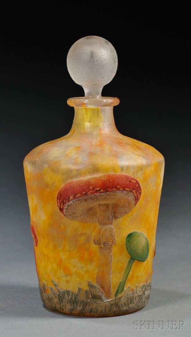 , Daum Enameled Cameo Glass Bottle, Art glass, Sto: Daum Enameled Cameo Glass Bottle Art glass Nancy, France, early 20th century Stoppered bottle form decorated with mushrooms in reds, brown, and green on mottled amber ground, marked in enamel Daum Nan