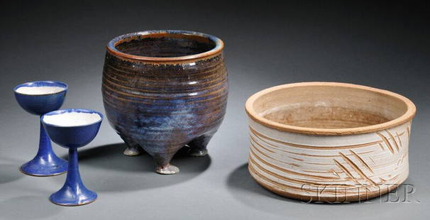 , Four William Wyman Studio Pottery Items, Earthen: Four William Wyman Studio Pottery Items Earthenware East Weymouth, Massachusetts, 1922-80 Round vessel raised on three feet in mottled blue and dark brown glaze, inscribed Wyman 64 on base; wide cylin