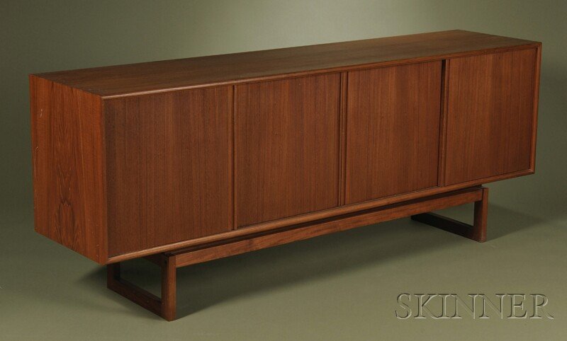 , Scandinavian Design Credenza, Teak veneers, Rect: Scandinavian Design Credenza Teak veneers Mid-20th century Rectangular top over three compartment with sliding doors, center compartment with three drawers, raised on rectangular u-shape base frame, h