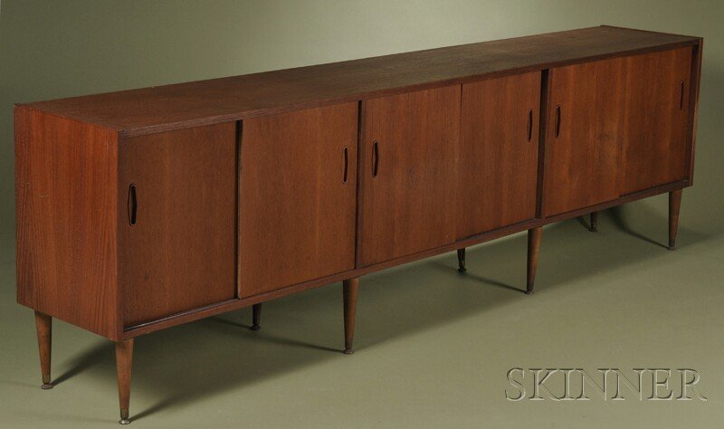 , Scandinavian Design Sideboard, Teak veneer, Rect: Scandinavian Design Sideboard Teak veneer Mid-20th century Rectangular top over three compartments with sliding doors, interior fitted with two shelves, raised on eight tapering cylindrical legs with 