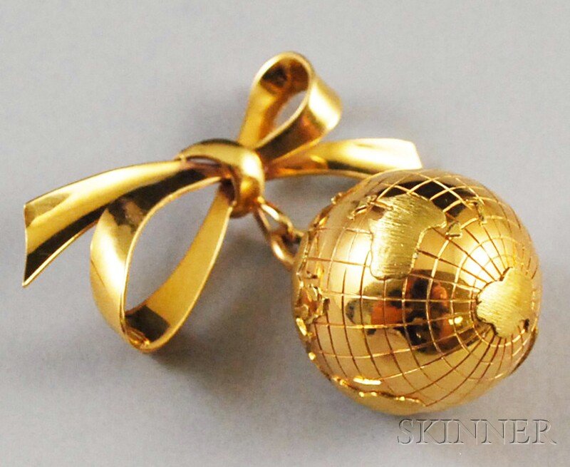 Industria Argentina 18kt Gold Gem-set Globe Brooch: Industria Argentina 18kt Gold Gem-set Globe Brooch, formed as a world globe with brushed gold continents and diamond and red gemstone city markers, suspended from gold bow, total 12.0 dwt, wd. 1 7/8,