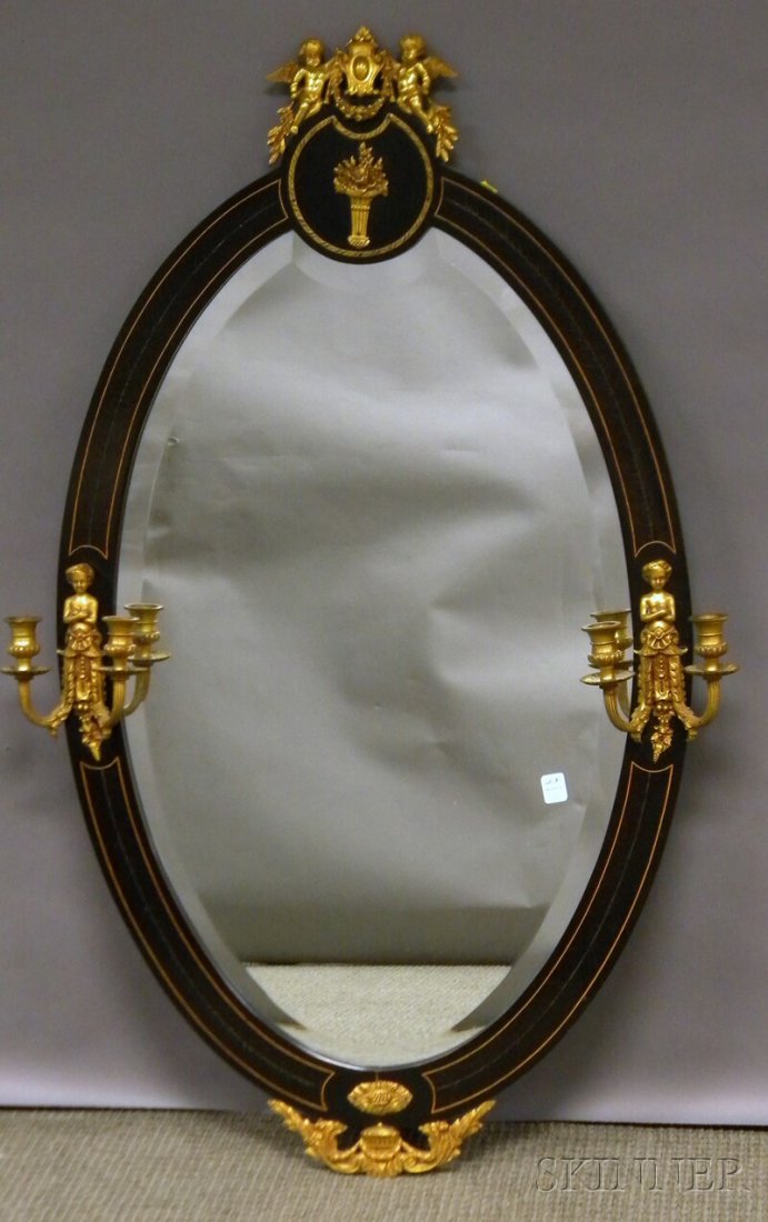 French-style Oval Brass-mounted and Inlaid Ebonize: French-style Oval Brass-mounted and Inlaid Ebonized Wood Veneered Mirror, with a pair of double candle arms and beveled glass, lg. 45 1/2 wd. 29 in.