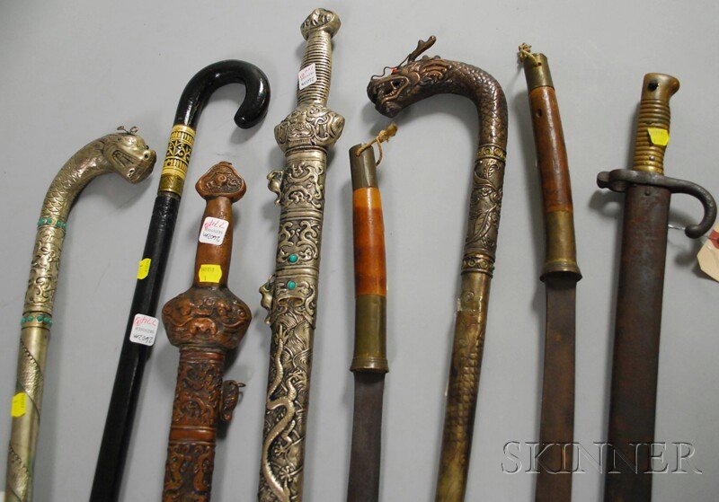 Eight Assorted Edged Weapons, two Asian jeweled si: Eight Assorted Edged Weapons, two Asian jeweled silvered metal cane swords, a pair of jeweled metal sword canes, and a bone inlaid wood cane sword, a pair of Asian swords, and a European WWI-era bayon