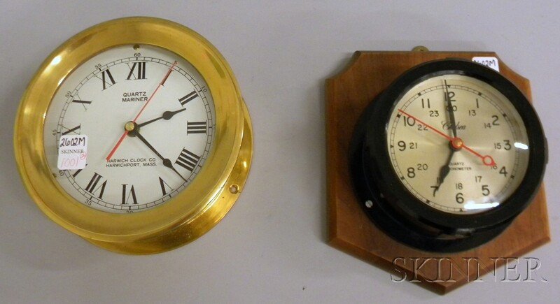 Two Quartz Wall Clocks, one in a black Bakelite c: Two Quartz Wall Clocks, one in a black Bakelite case by Chelsea and marked with maker's name and Quartz Chronometer, silvered dial with Arabic numerals, dia. 5; the other in a brass case, white dial w