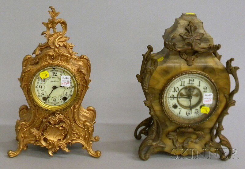 Two Louis XV-style Mantel Clocks, a cast iron Set: Two Louis XV-style Mantel Clocks, a cast iron Seth Thomas, 3 1/2-in. porcelain dial with Arabic numerals, eight-day time and strike movement, and a faux painted cast iron case by New Haven Clock Co.,