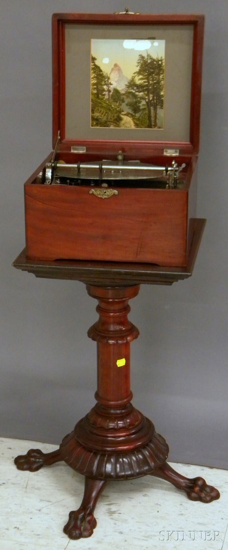 Swiss Mahogany Cased Mechanical 9 1/4-in. Disc Mu: Swiss Mahogany Cased Mechanical 9 1/4-in. Disc Music Player with a Carved Mahogany Stand, player with "ST" and star mark, stand ht. 22 1/2 in.