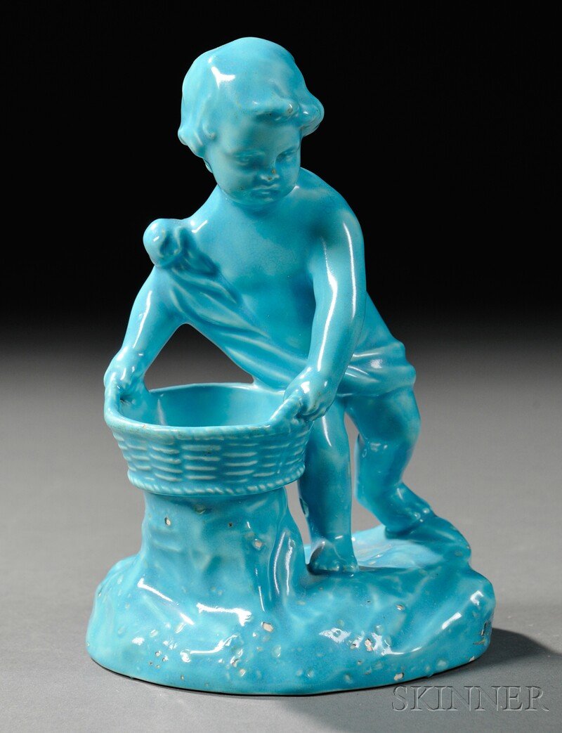 Wedgwood Turquoise-glazed Earthenware Figural Salt: Wedgwood Turquoise-glazed Earthenware Figural Salt, England, c. 1880, modeled as a scantily clad boy holding a basket, impressed mark, ht. 5 1/2 in.