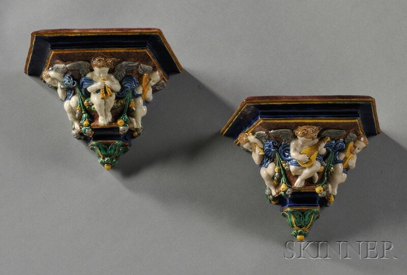 Pair of Majolica Wall Brackets, England, late 19th: Pair of Majolica Wall Brackets, England, late 19th century, attributed to George Pull, each with three angels playing musical instruments seated on pendant garlands, impressed mark, ht. to 6 in.