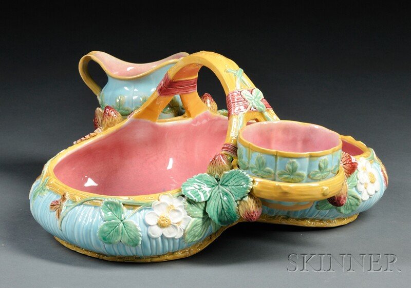 Victoria Pottery Co. Majolica Strawberry Dish, Eng: Victoria Pottery Co. Majolica Strawberry Dish, England, c. 1885, formed as a basket adorned with strawberries and blossoms, with holders at the base of the handle for the cream and sugar bowls, with i