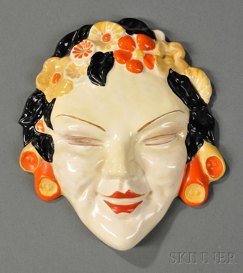 Clarice Cliff Wall Hanging, England, 20th century: Clarice Cliff Wall Hanging, England, 20th century, formed as a female head adorned with flowers, with the designor's signature on the reverse, ht. 6 5/8 in.