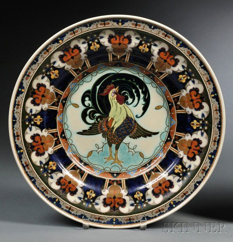 Rosenberg Den Haag Gouda Pottery High Glaze Charge: Rosenberg Den Haag Gouda Pottery High Glaze Charger, Holland, early 20th century, decorated with a rooster to the center and rim with abstract motifs on a dark ground, with painted factory mark, incis