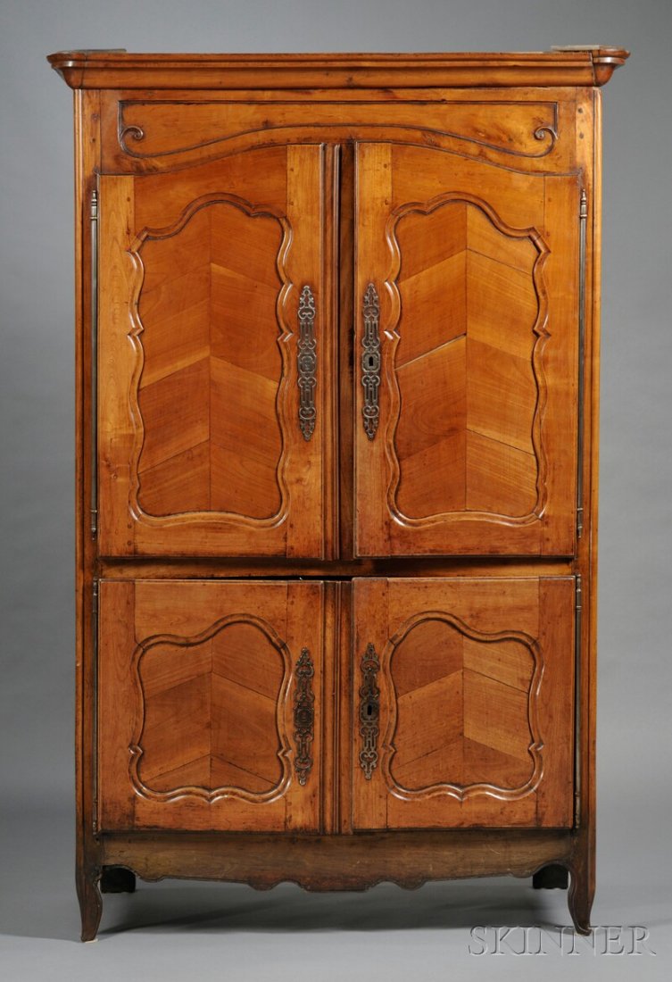 French Provincial Fruitwood Buffet, 19th century,: French Provincial Fruitwood Buffet, 19th century, the two sets of double doors with shaped fielded panels inset with chevron design, and pewter hardware, with carved skirt and squat cabriole feet, ht.