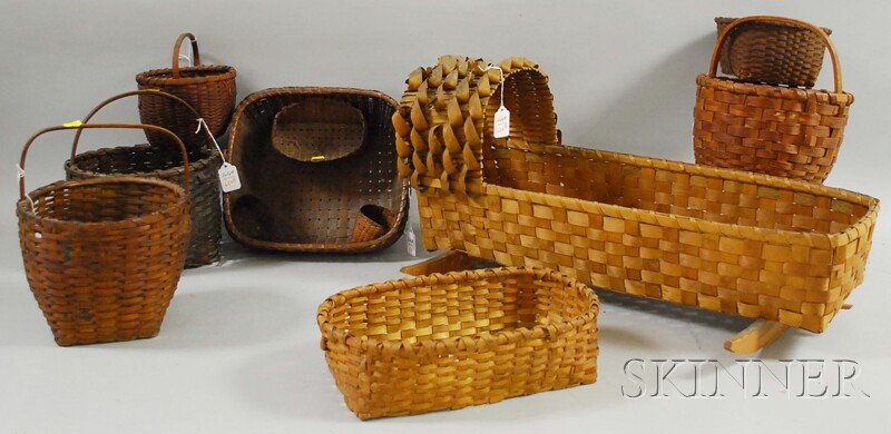 Seven Woven Splint Open Baskets and a Hooded Rocki: Seven Woven Splint Open Baskets and a Hooded Rocking Doll's Cradle.