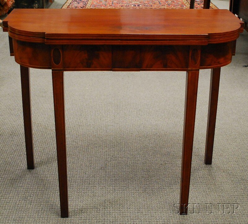 Federal Mahogany String-inlaid Card Table, probab: Federal Mahogany String-inlaid Card Table, probably Massachusetts, c. 1800, the folding top with ovolo corners and inlaid edge, on conforming base centering a raised panel joined to the square taperin