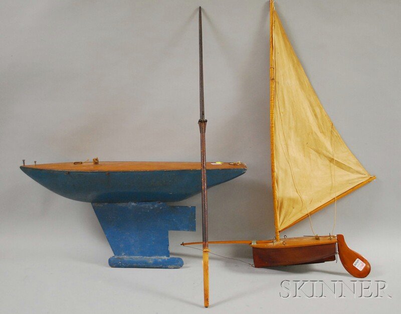 Two Wooden Pond Sail Boats, a small catboat model: Two Wooden Pond Sail Boats, a small catboat model and a blue-painted boat, hull lg. 9 1/4 and 23 3/4 in.