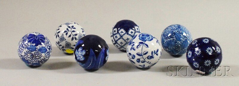 Seven Blue and White Carpet Balls, in a variety o: Seven Blue and White Carpet Balls, in a variety of floral and abstract patterns, (some chips), approx. dia. 3 1/2 in.