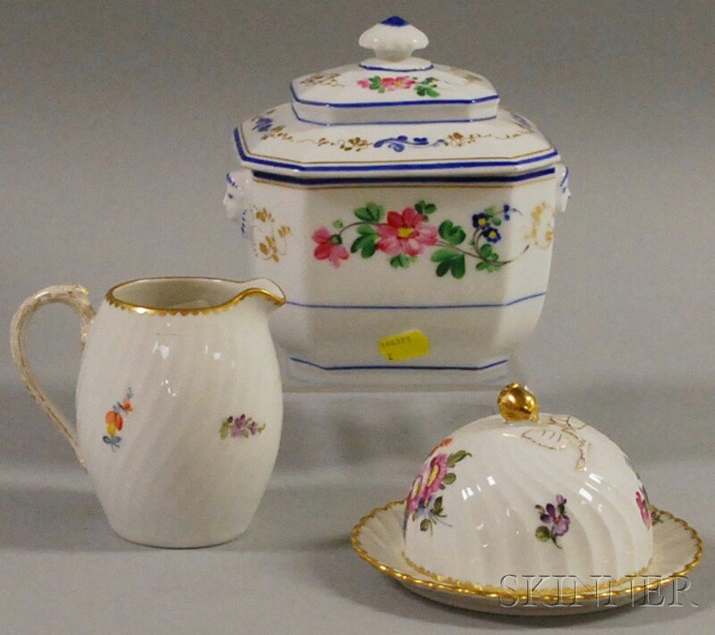 Three European Porcelain Table Articles, an octag: Three European Porcelain Table Articles, an octagonal covered sugar bowl with impressed crossed swords mark to base (rim chip, crack to inside of lid), and two floral-decorated Nymphenburg items, a cr