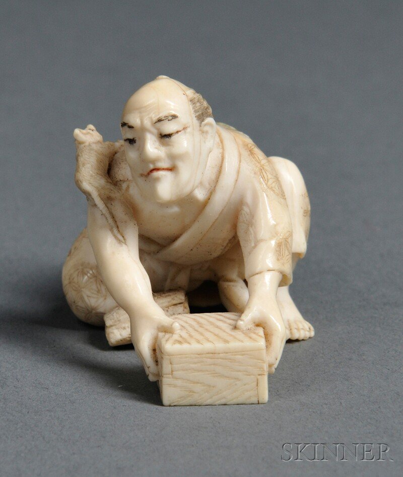 Ivory Netsuke, Japan, 19th century, in the form of: Ivory Netsuke, Japan, 19th century, in the form of a crouched figure holding a box, with a rat on his shoulder, signed, ht. 1 1/8 in.